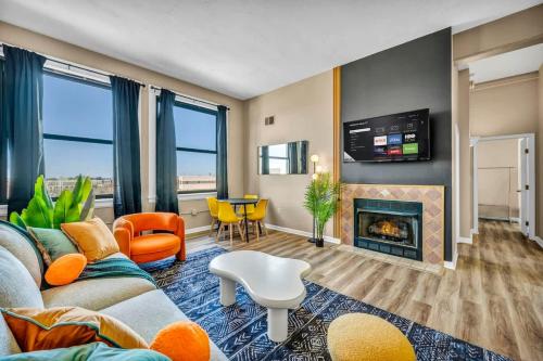 a living room with a couch and a fireplace at Funky 2B Apt in Downtown Cleveland FREE Parking in Cleveland