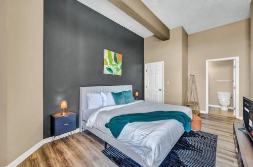 a bedroom with a large bed and a television at Funky 2B Apt in Downtown Cleveland FREE Parking in Cleveland