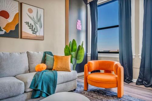 a living room with a couch and a chair at Funky 2B Apt in Downtown Cleveland FREE Parking in Cleveland