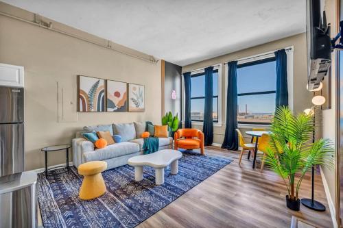 a living room with a couch and a table at Funky 2B Apt in Downtown Cleveland FREE Parking in Cleveland