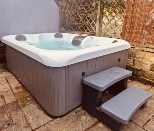 a bath tub with a bench in front of it at Peak District Home from Home! in Grindleford Bridge