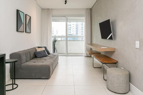a living room with a couch and a table at WI-FI 200MB | Rooftop | Pool with Sea View #CA70D in Florianópolis