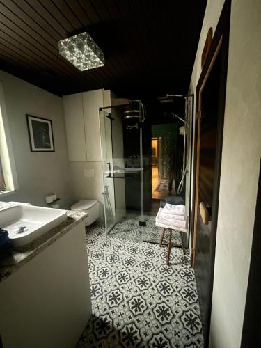 a bathroom with a sink and a shower and a toilet at Хлеча house in Stantsiya Korchi
