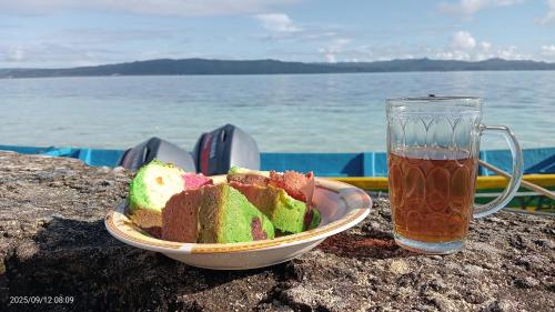 a bowl of bread next to a glass of tea at Ombar Guest House in Minyaifuin