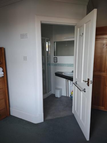 an open door to a bathroom with a sink at 95 St Mary Street in Kirkcudbright
