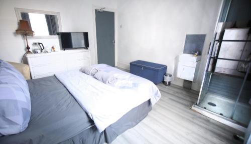 a bedroom with a bed and a television in it at The Wellington Restaurant and Bar in Portsmouth