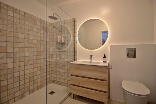 a bathroom with a toilet and a sink and a mirror at Francisco Vau Apartment in Portimão