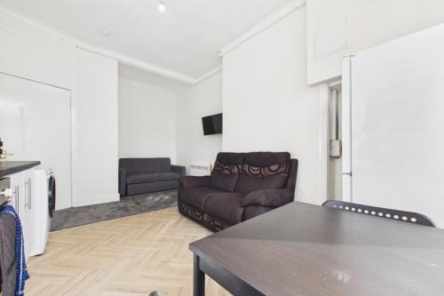 a living room with a couch and a table at West End Traditional Flat with Free Parking in Scotstoun West Station