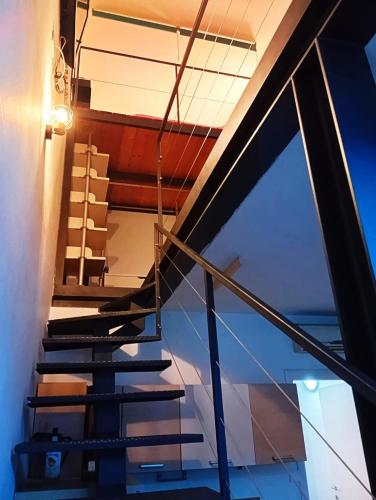 a set of stairs in a house with a window at Loft Bovisa in Milan