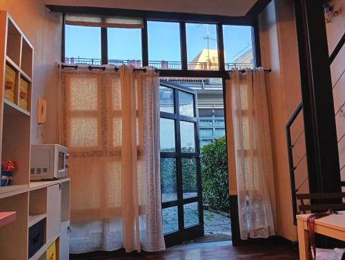 a room with a door open to a window at Loft Bovisa in Milan
