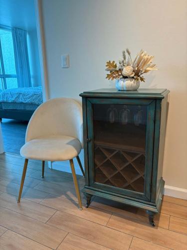 a chair and a table with a vase on top at Aqua Breeze Paradise in Fort Myers