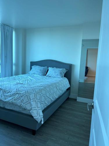 a bedroom with a bed with a blue light on it at Aqua Breeze Paradise in Fort Myers