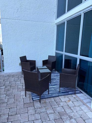 a group of chairs and a table on a patio at Aqua Breeze Paradise in Fort Myers
