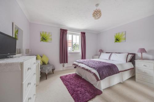 a white bedroom with a bed and a tv at 3 Bed in Wangford oc-frs in Wangford