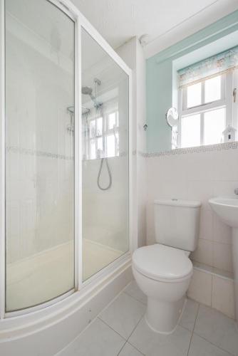 a bathroom with a shower and a toilet and a sink at 3 Bed in Wangford oc-frs in Wangford