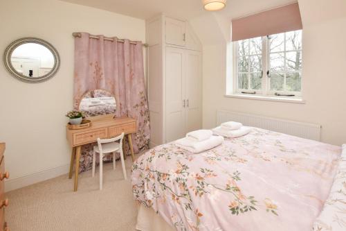 a bedroom with a bed and a desk and a mirror at 2 Bed in Biddenden oc-cb616 in Biddenden