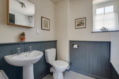 a bathroom with a white toilet and a sink at 2 Bed in Field Dalling oc-1988 in Saxlingham