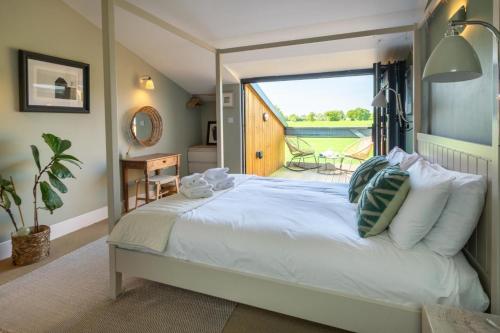 a bedroom with a large white bed with a large window at 3 Bed in Henham oc-3nvf in Wangford
