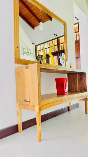 a wooden cabinet with a mirror on top of it at Villa 188 Yala in Tissamaharama