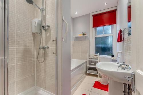 a bathroom with a shower and a sink and a tub at 2 Bed in Bexhill-on-Sea oc-t29534 in Bexhill