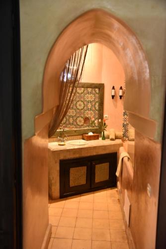 a bathroom with a sink and a mirror at Riad Du Petit Prince in Marrakesh