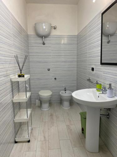 a bathroom with a sink and a toilet at Home Ringo in Belvedere Marittimo