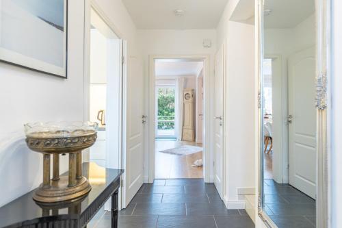 a hallway with a console table and a mirror at Hjertets Hus in Humptrup