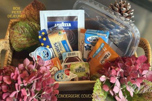 un cesto pieno di diversi tipi di cibo e fiori di Gîte ty glas a Lézardrieux