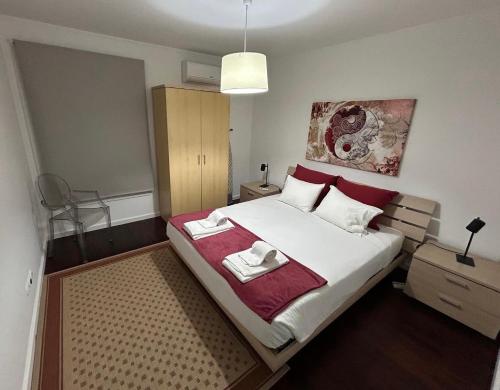a bedroom with a bed with two towels on it at 2Stay - A1 in Ponta Delgada