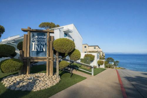 a sign that says cancer hour inn with the ocean in the background at Cannery Row Inn in Monterey