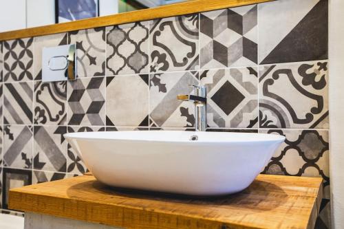 a white sink on a wooden counter in a bathroom at The Cartshed in Llanvetherine