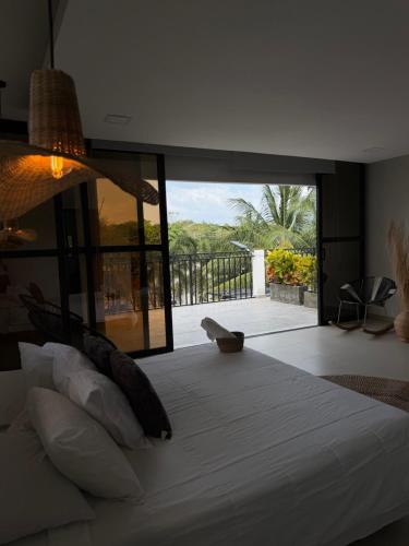 a bedroom with a large bed with a large glass window at Casa Del Río in Montería