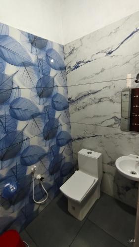 a bathroom with a toilet and a sink at Happy Homes in Palakkad