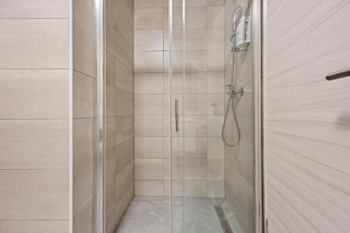 a shower with a glass door in a bathroom at Apartment Lola in Peroj