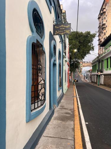 a building with blue windows on a city street at Posada La Pastora Colonial in Caracas