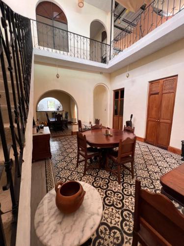 a large room with a table and chairs and a balcony at Posada La Pastora Colonial in Caracas
