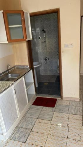 a bathroom with a shower and a sink and a tub at House Al Ain - 5 in Al Ain