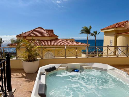 a hot tub on the balcony of a house at Ocean View Vila with Private Jacuzzi in Los Cristianos