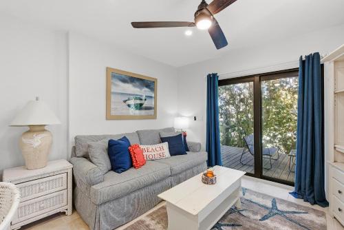 a living room with a couch and a table at Sea Dunes Nautilus B8 in New Smyrna Beach