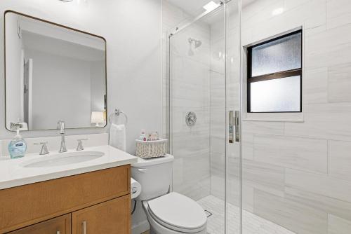 a bathroom with a toilet and a sink and a shower at Sea Dunes Nautilus B8 in New Smyrna Beach