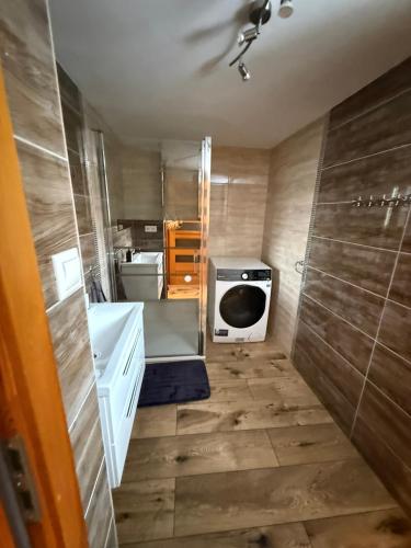 a small bathroom with a sink and a stove at Chata Diana in Oravice