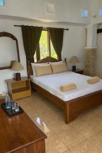 a bedroom with a large bed in a room at Villa Stella Garden in Senggigi