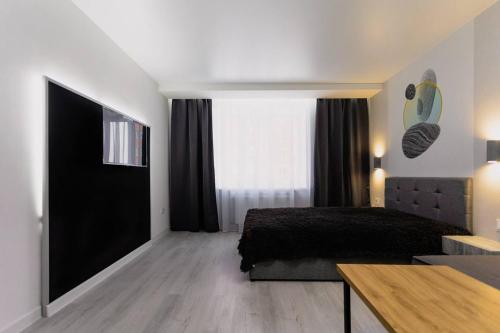 a bedroom with a bed and a large window at Center 2 poverh Ecoflow VIP TopApart in Sumy