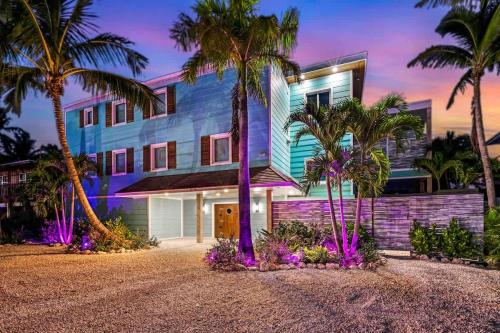 a house with palm trees in front of it at Bumpa's Big House in Marathon