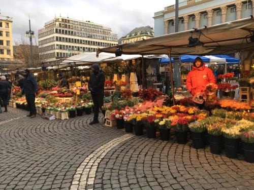 a market with a bunch of flowers on a street at ProfilHotels Central in Stockholm