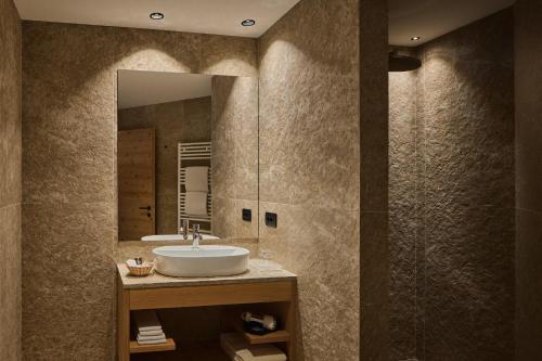 a bathroom with a sink and a mirror at Hotel Mesdi in Arabba