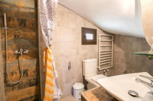 a bathroom with a toilet and a sink at Agali Villa in Limenaria