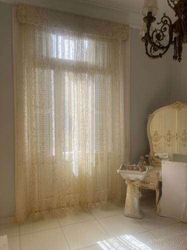 a room with a window with a sink and a chair at Graeco-Roman Residence-Delilah in Alexandria