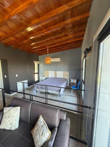 a living room with a bed and a couch at Sol de campo in Santa Clara del Mar