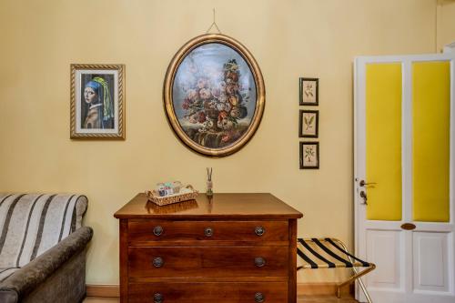 a room with a dresser and a painting on the wall at Casa Esvael - Historic Rooms in Verona City Center in Verona